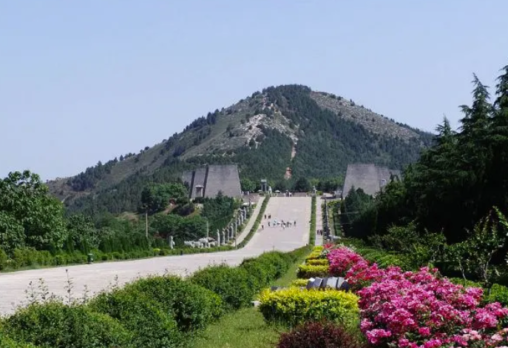 Long pathway to Qianling Mausoleum on a mountain, lined with flowers and trees